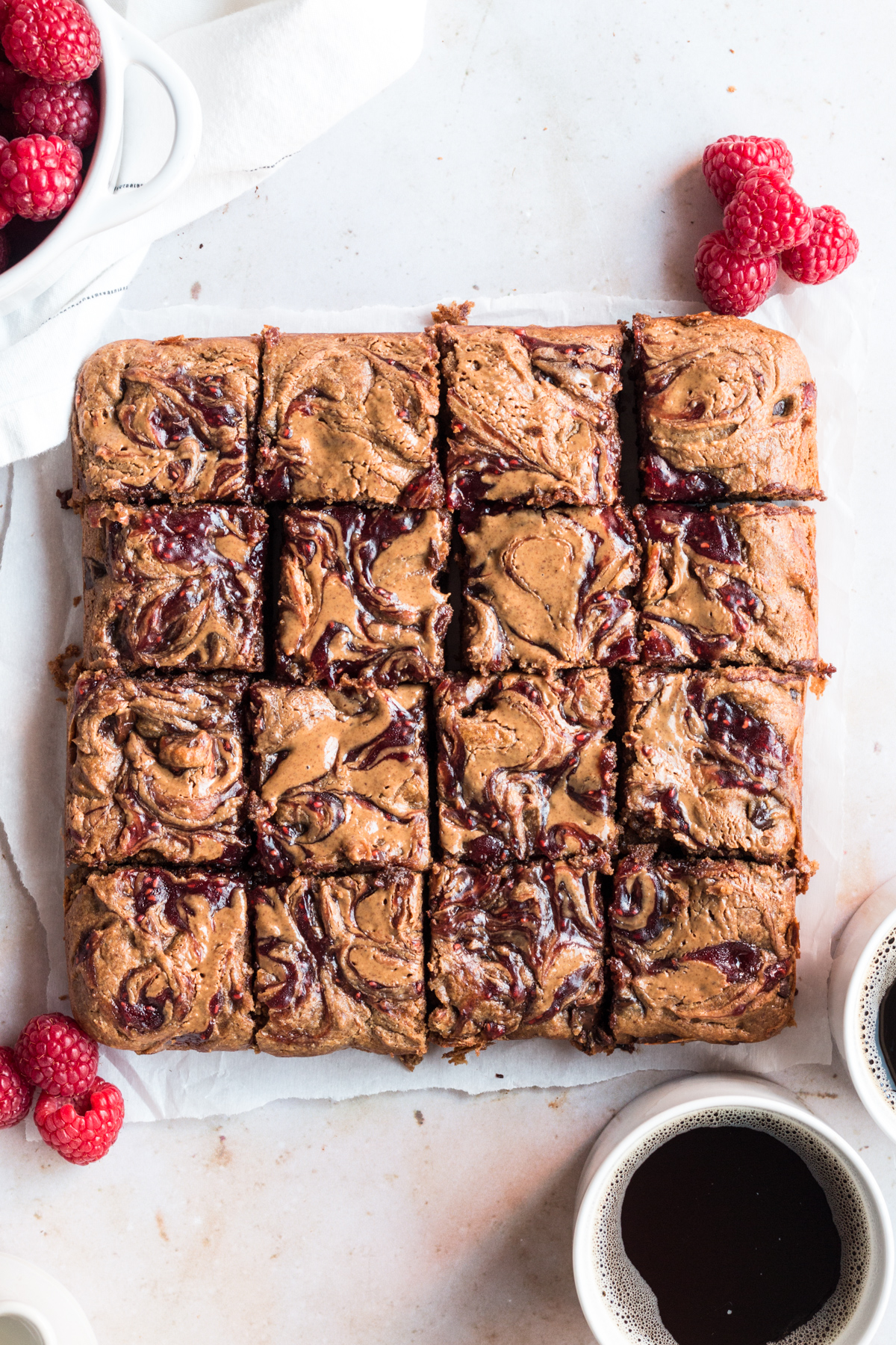top down image of batch of raspberry almond flour blondies cut into squares