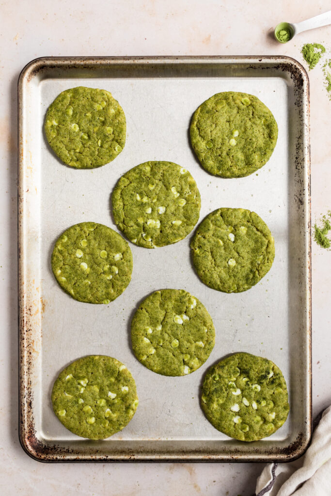 8 matcha cookies on a sheet pan