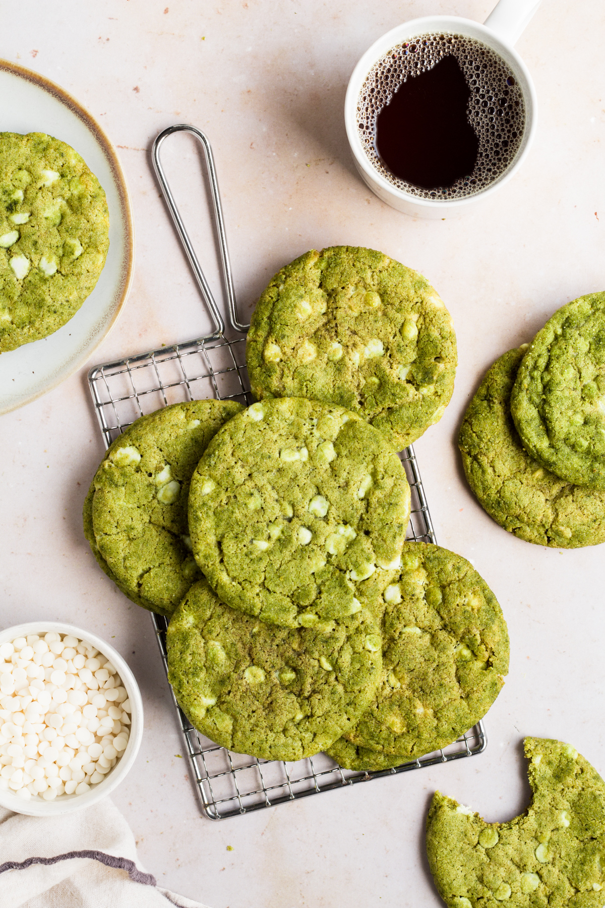 flat lay of matcha cookies on a wire rack on a marble backdrop