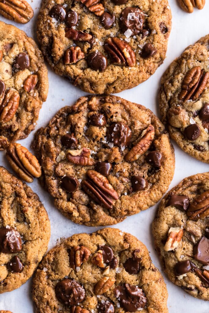 close up flat lay shot of chocolate chip pecan cookies